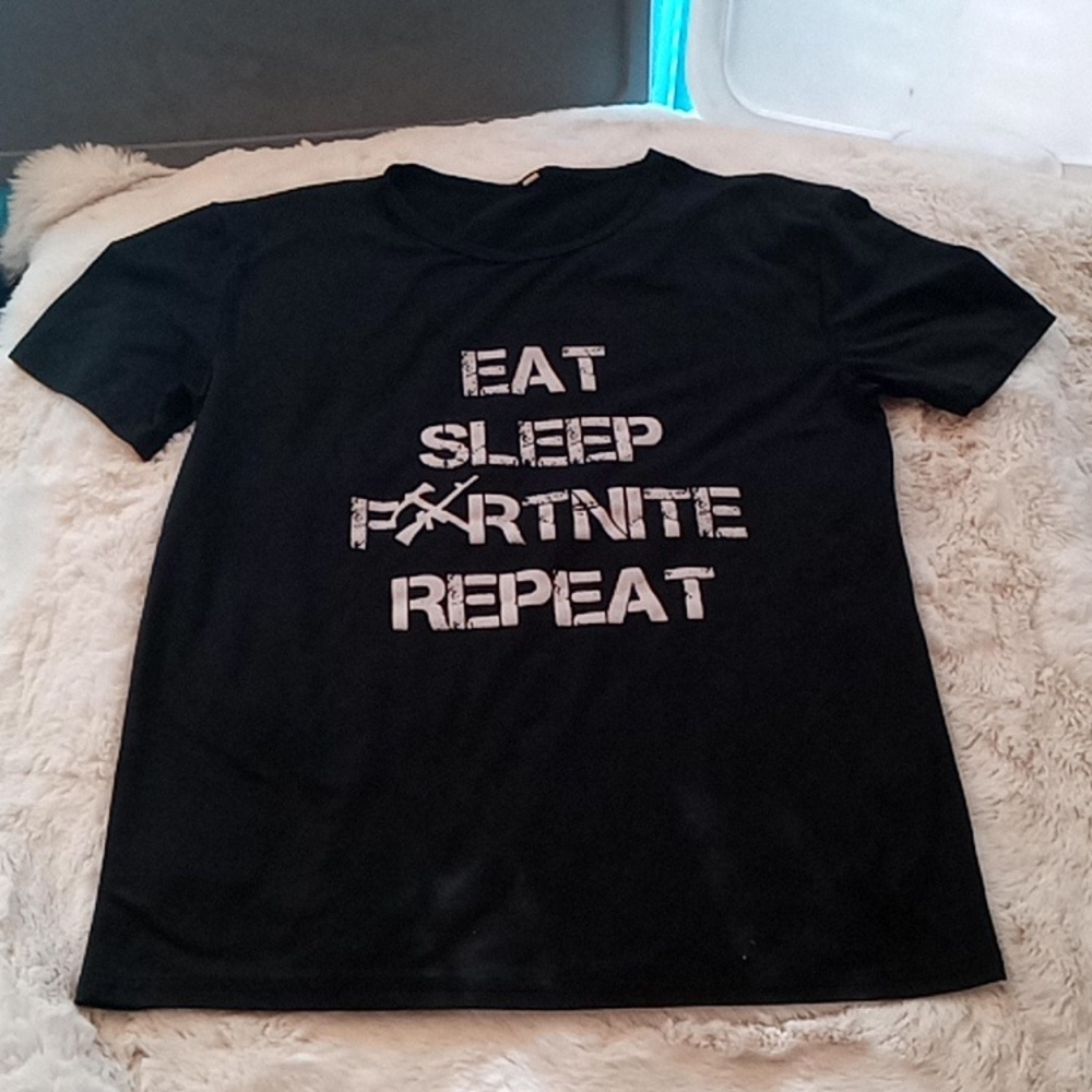 A women's black T-shirt with the slogan eat, sleep, Fortnite, repeat